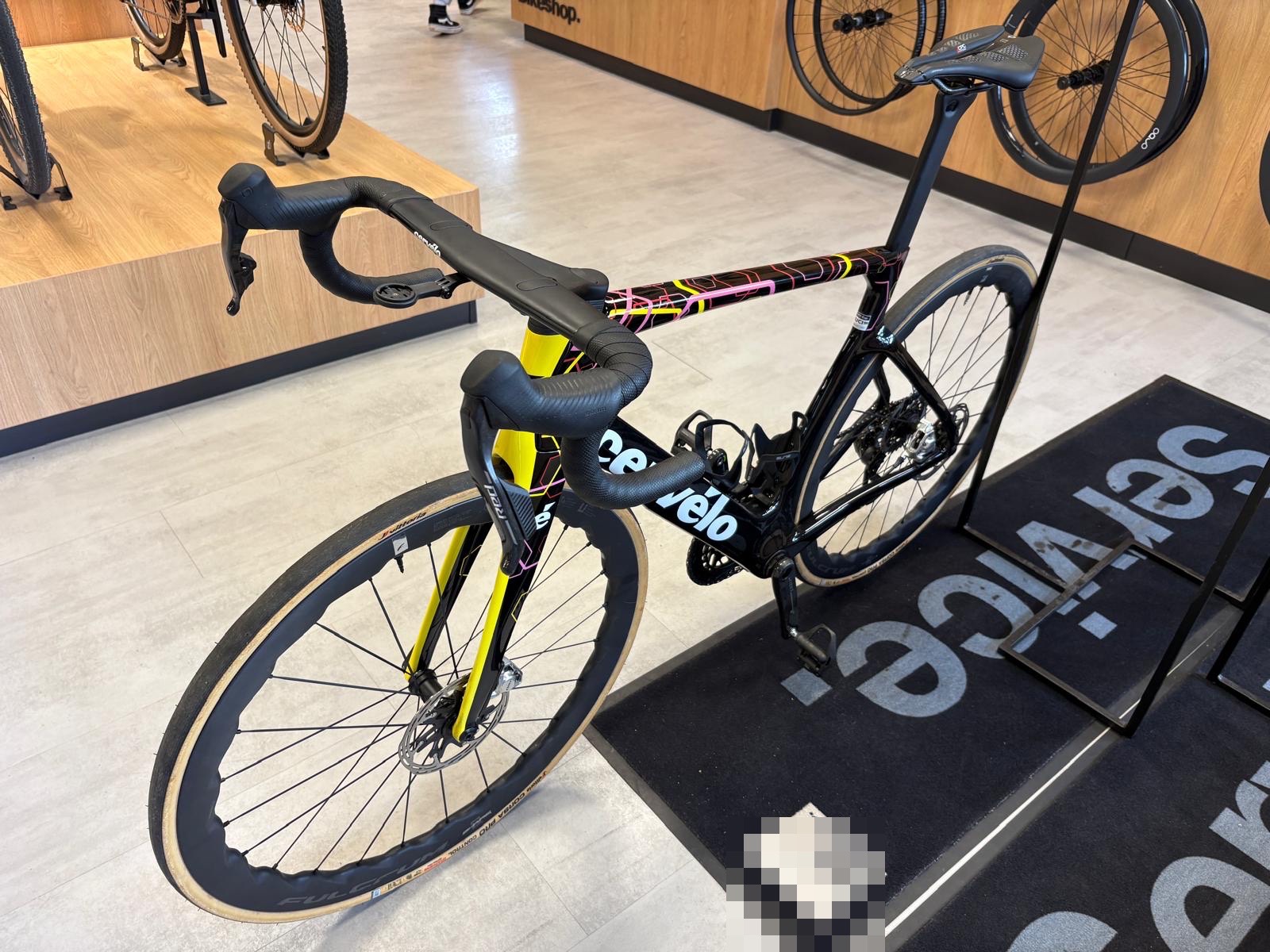 Schwarz-gelbes Carbon-Rennrad mit Scheibenbremsen in einer Fahrradwerkstatt